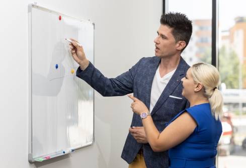 two colleagues with a whiteboard